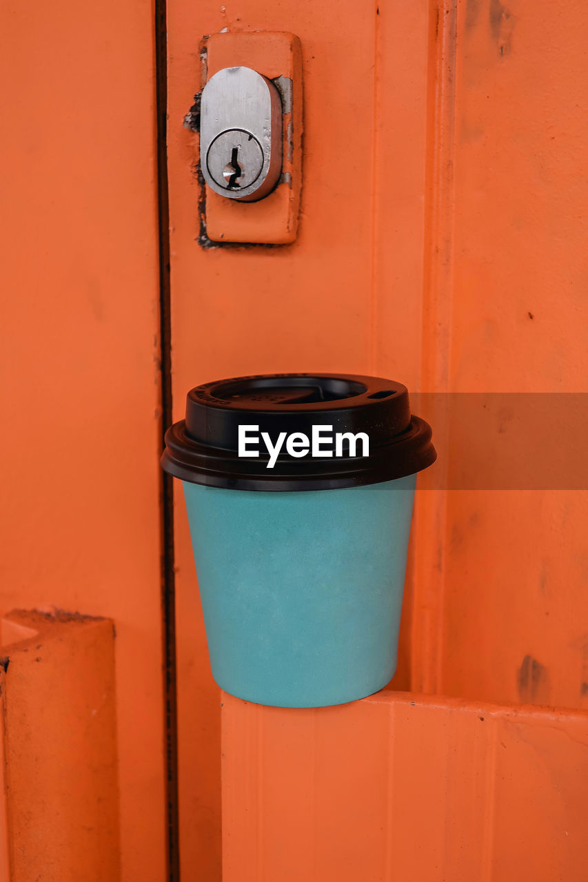 red, blue, no people, orange color, door, wall - building feature, entrance, wall, waste container, architecture, wood, protection, metal, yellow, outdoors, built structure, orange, day, security