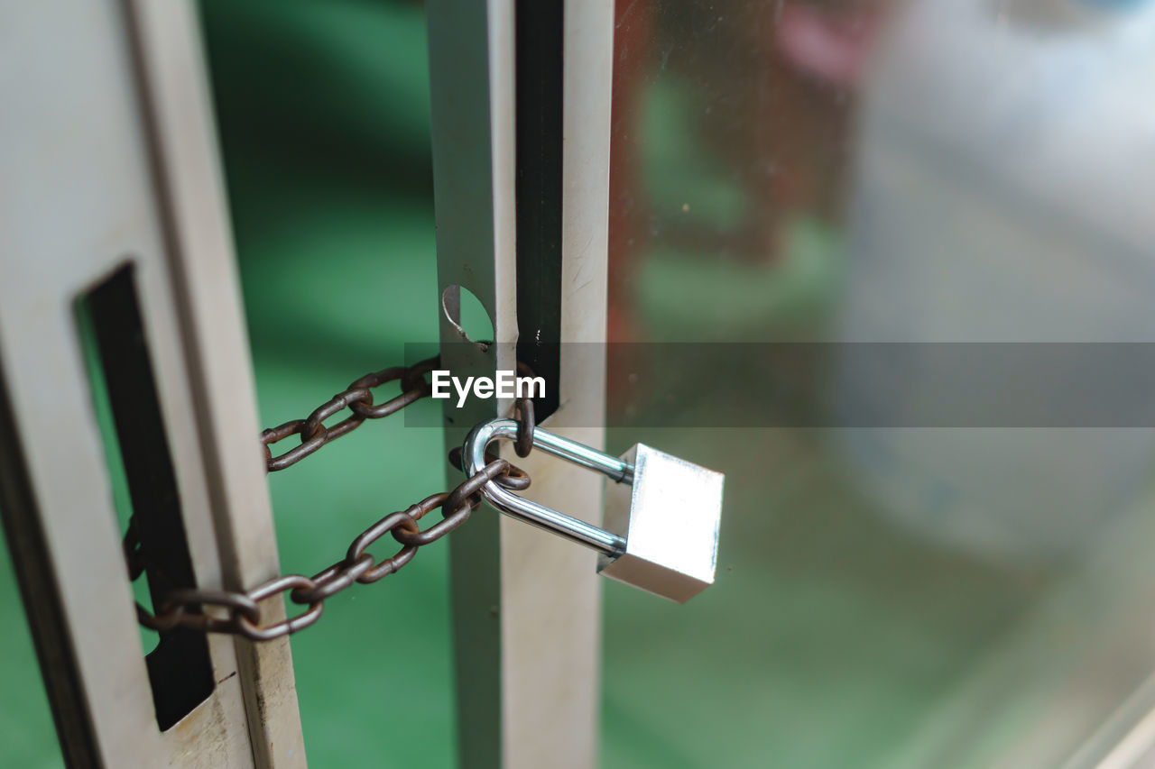 CLOSE-UP OF PADLOCK ON WINDOW