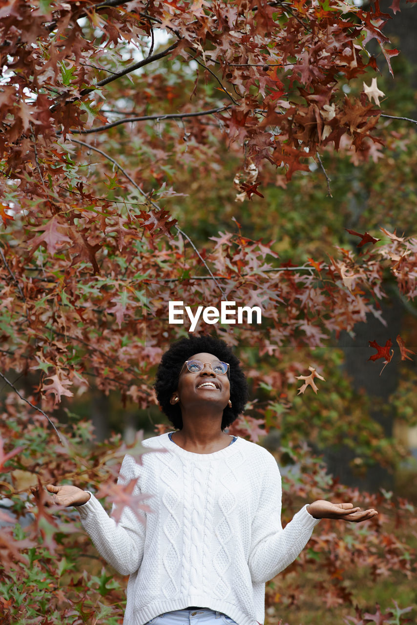 Woman standing by plants