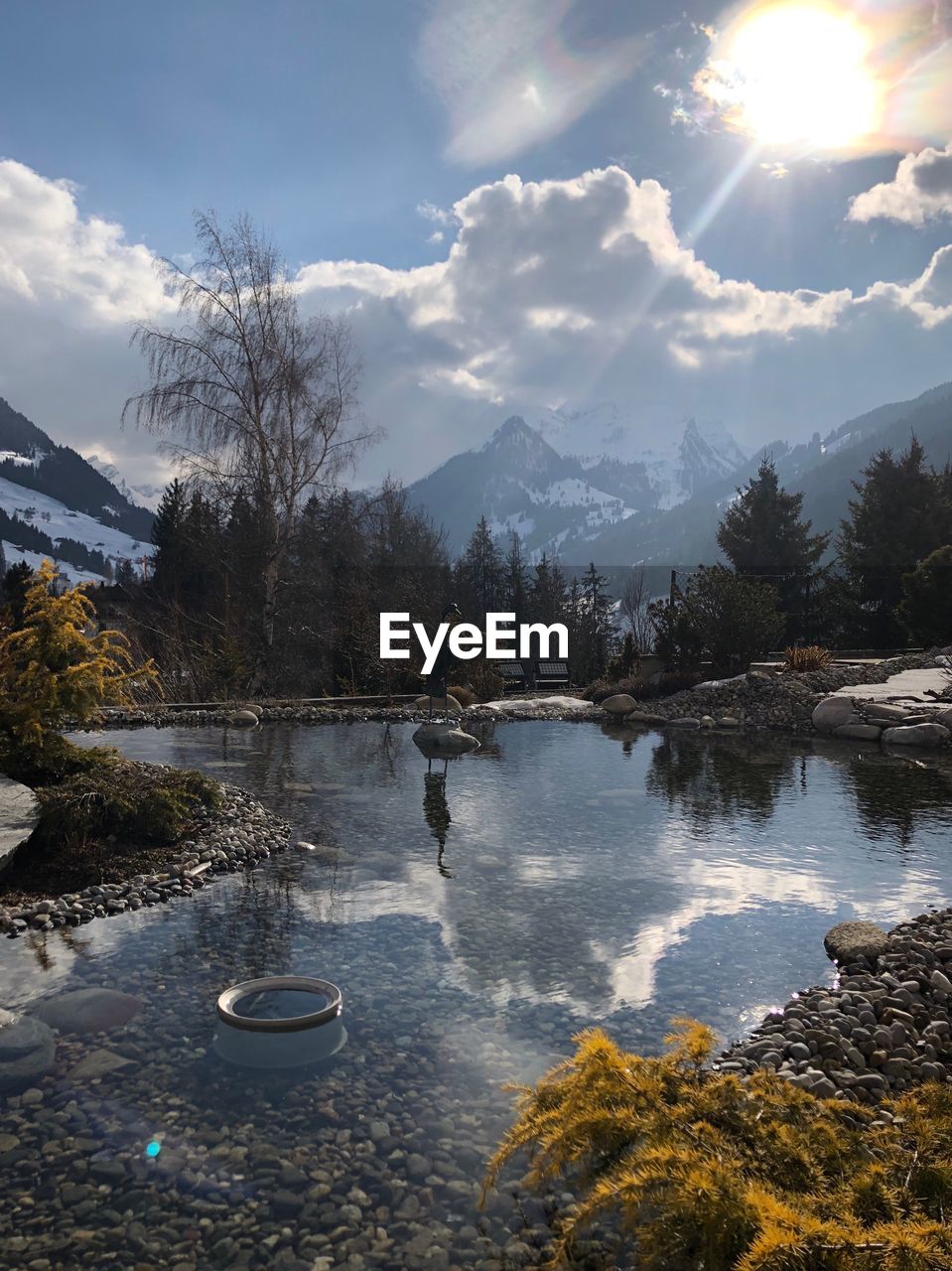 Scenic view of lake against sky during sunny day