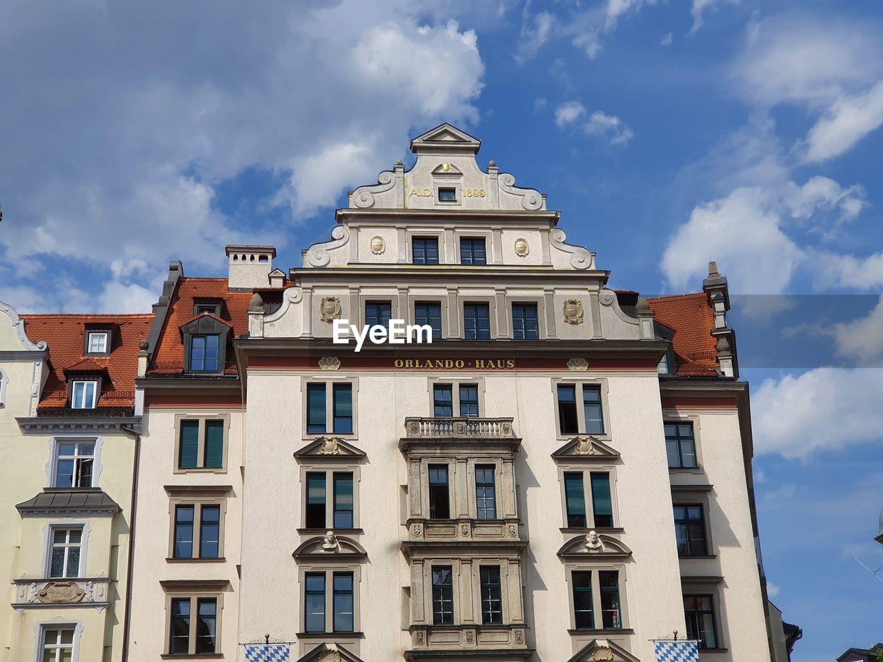 Low angle view of building against cloudy sky