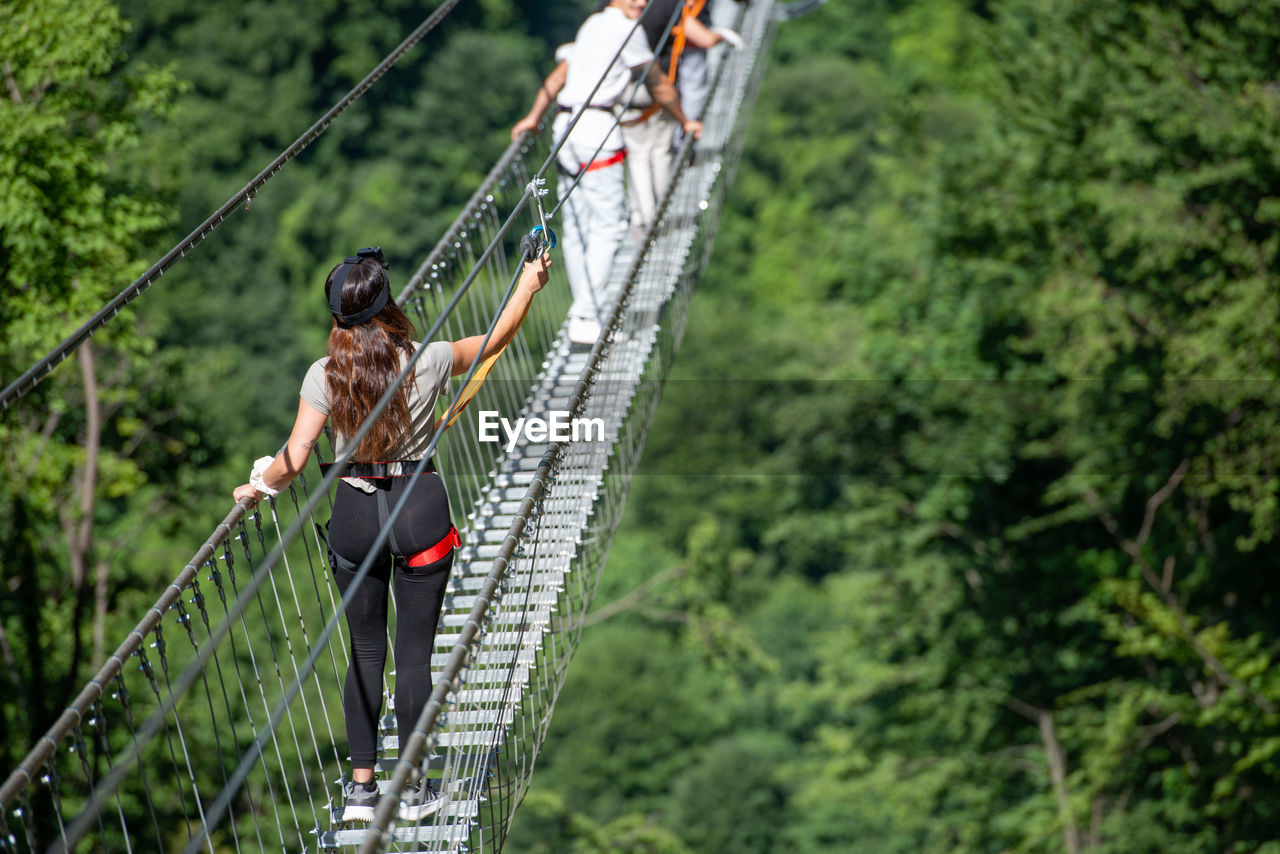 Low angle view of man standing on rope