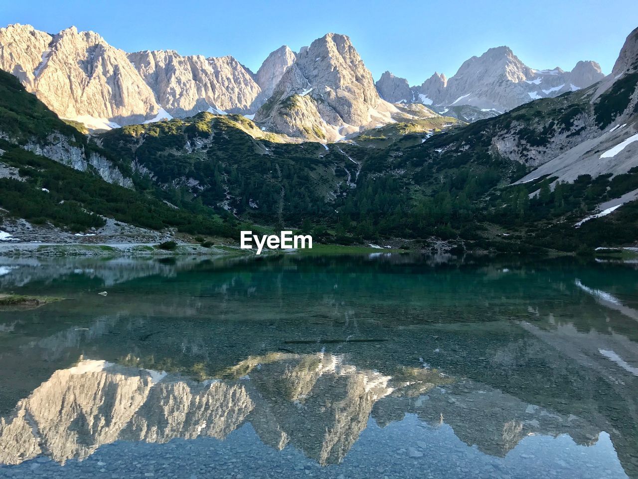 Scenic view of snowcapped mountains by lake