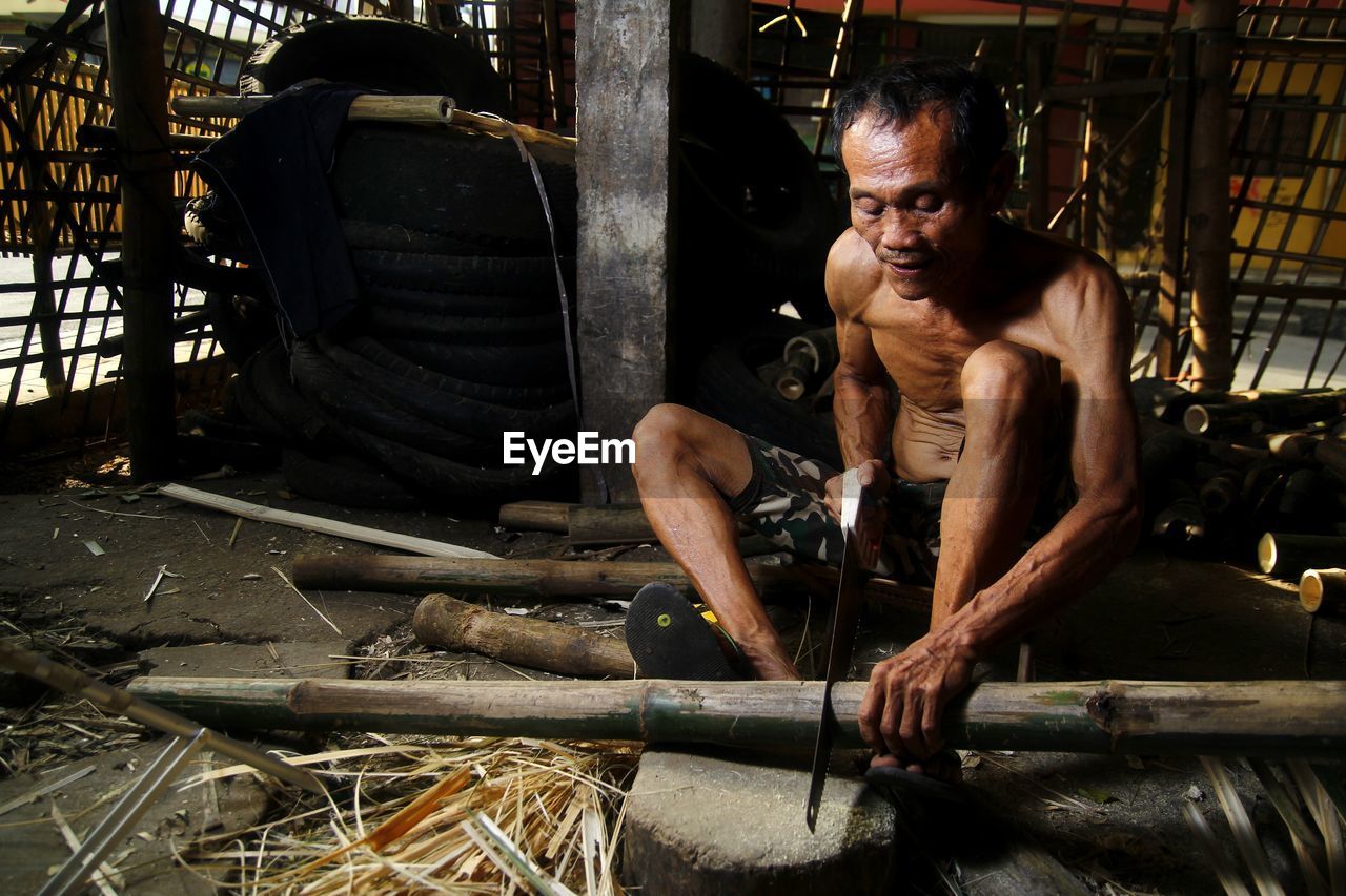 MAN WORKING ON METAL STRUCTURE IN CONTAINER