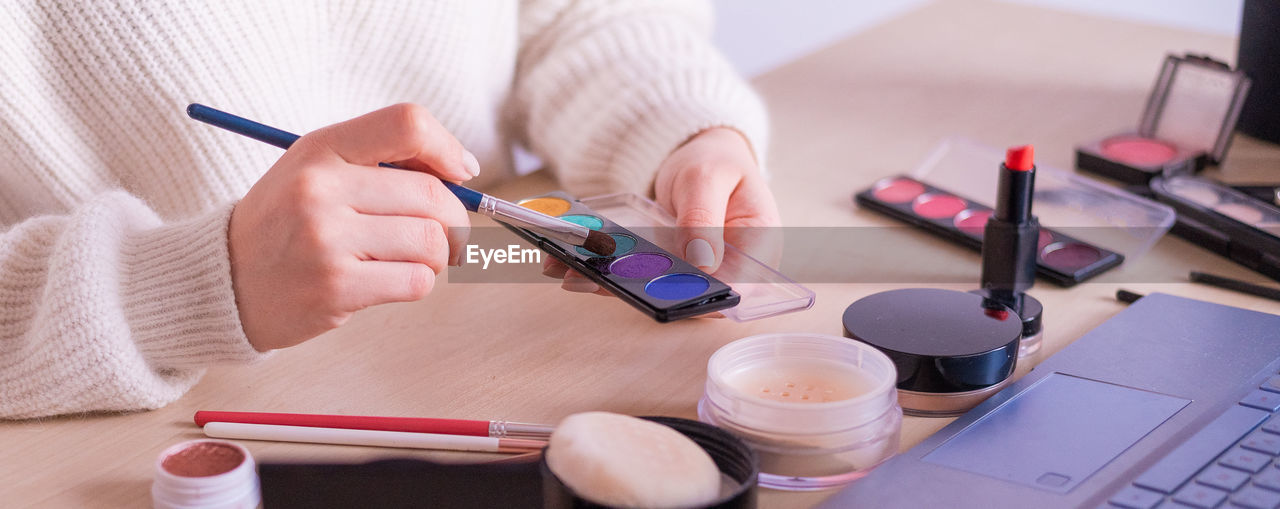 Close-up of woman using mobile phone on table