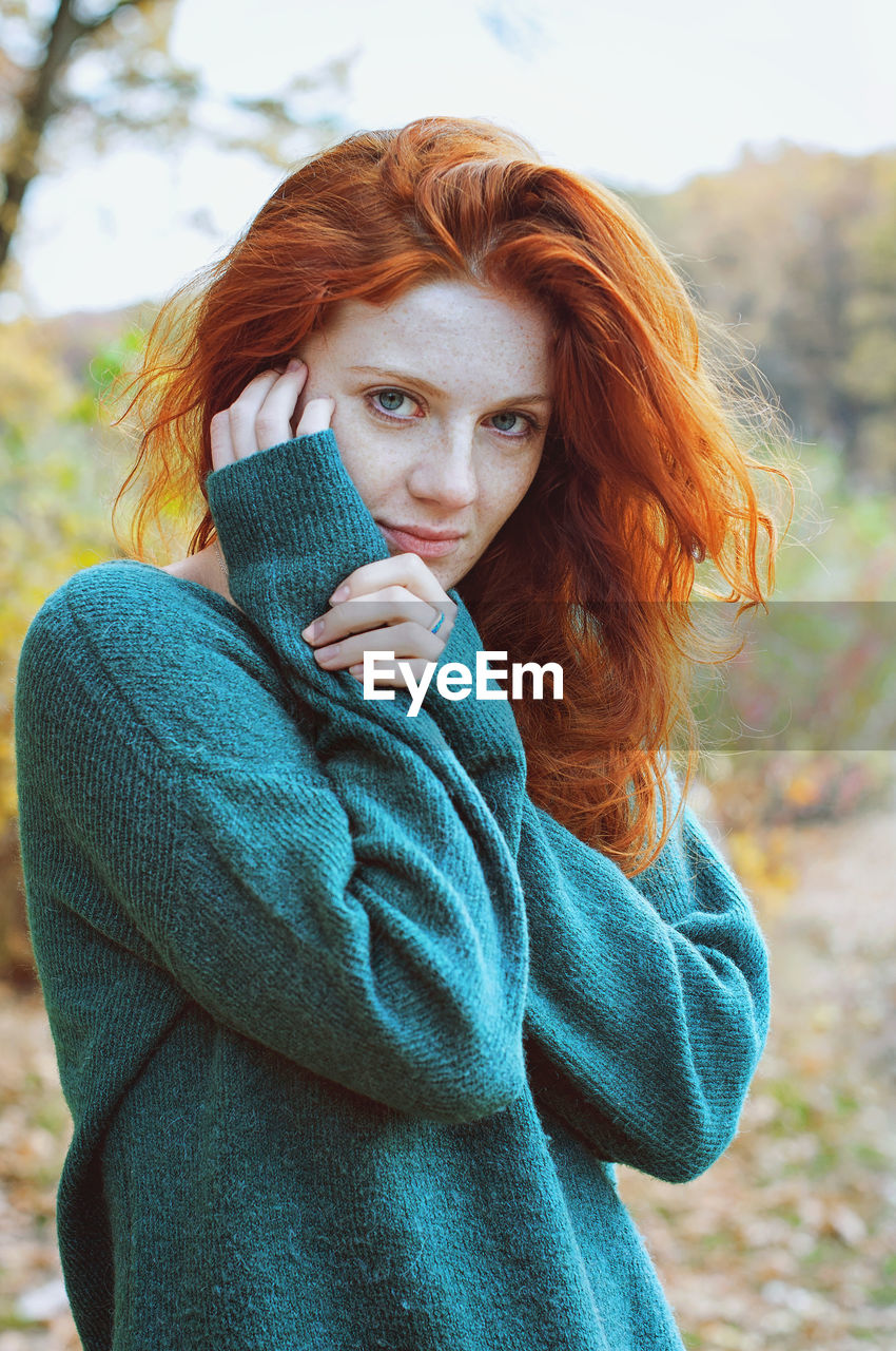 Portrait of a young redhead woman with freckles.