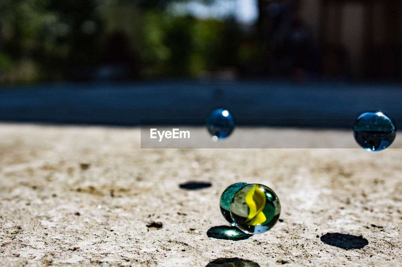 Close-up of a marbles on concrete 