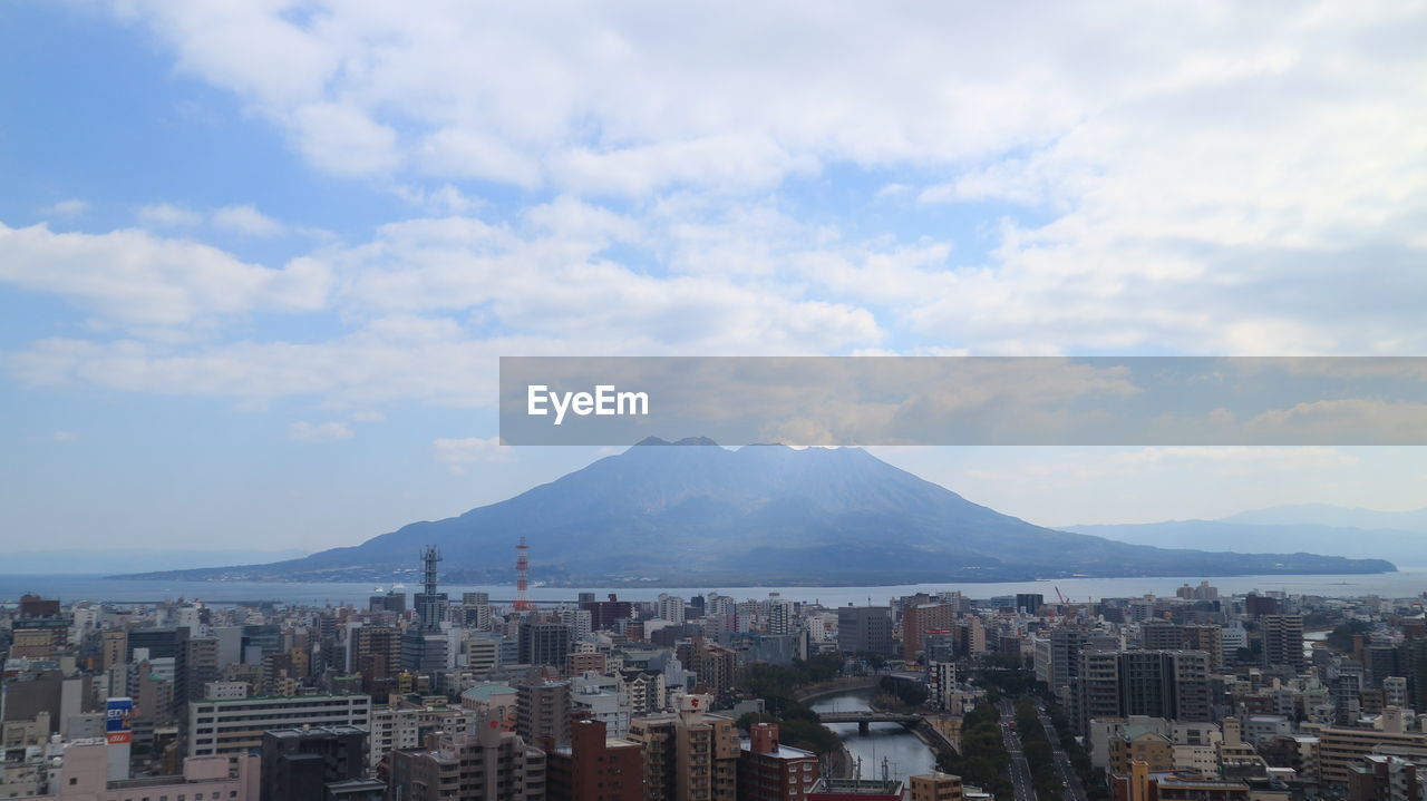 Cityscape against cloudy sky