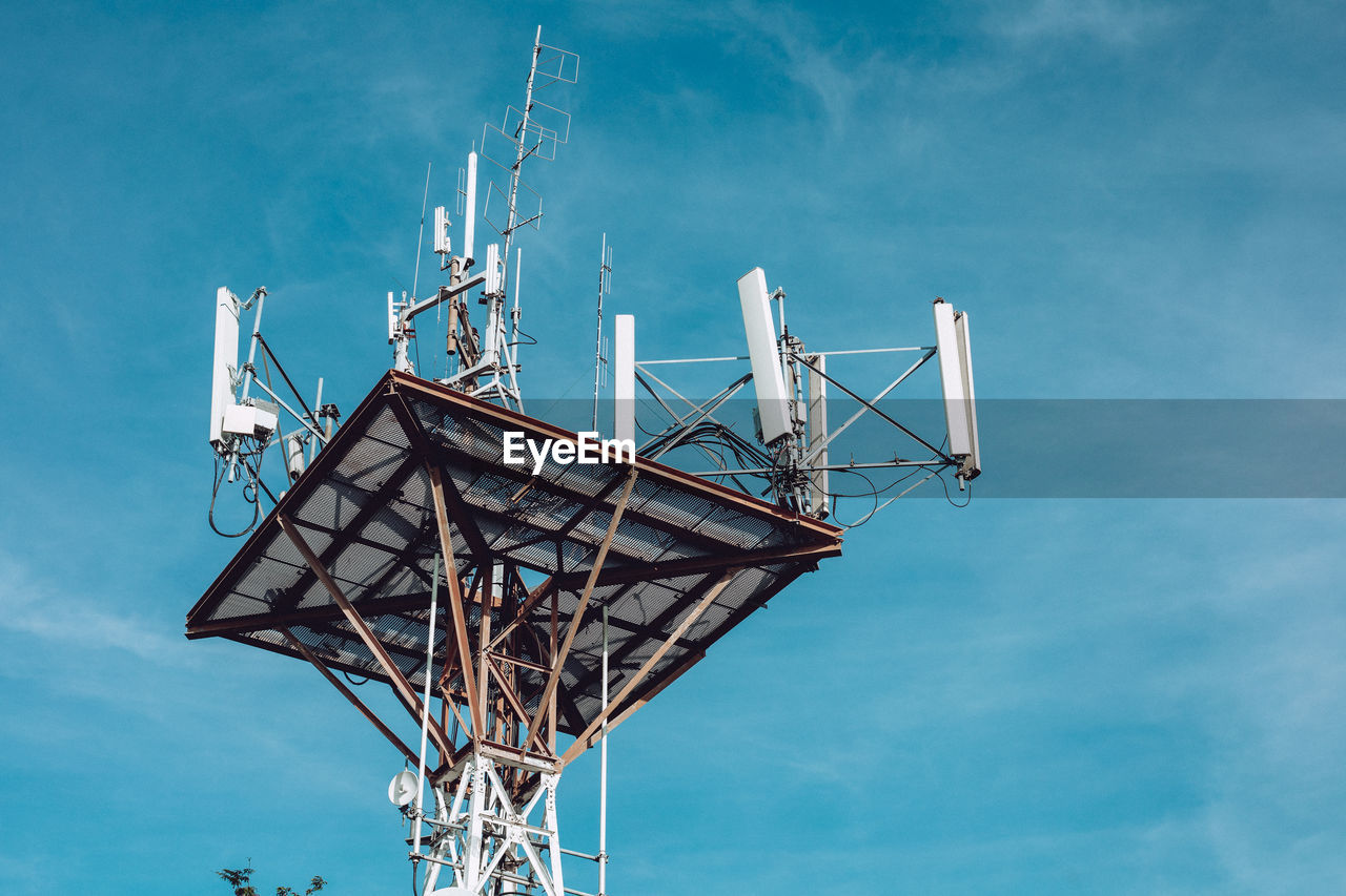 Low angle view of communications tower against sky