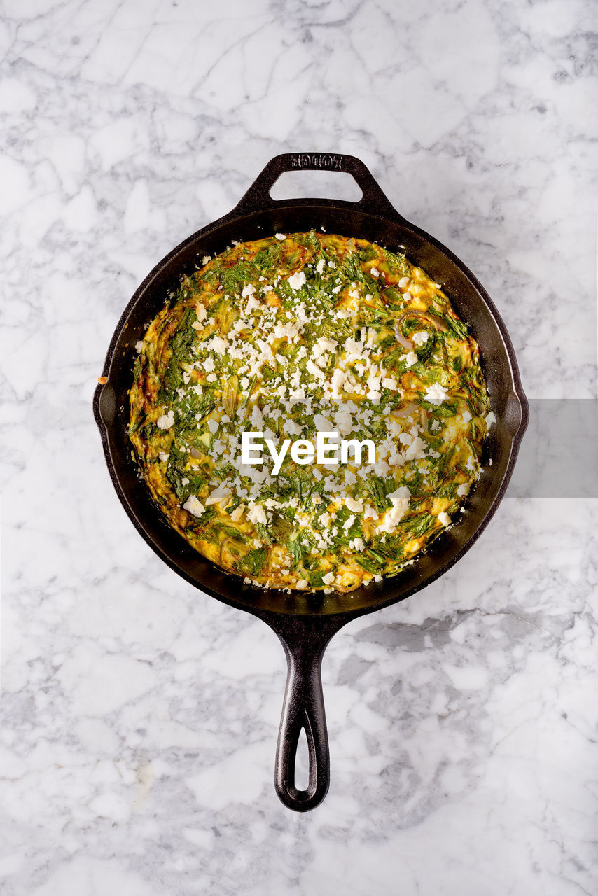 High angle view of food served in cooking pan on table