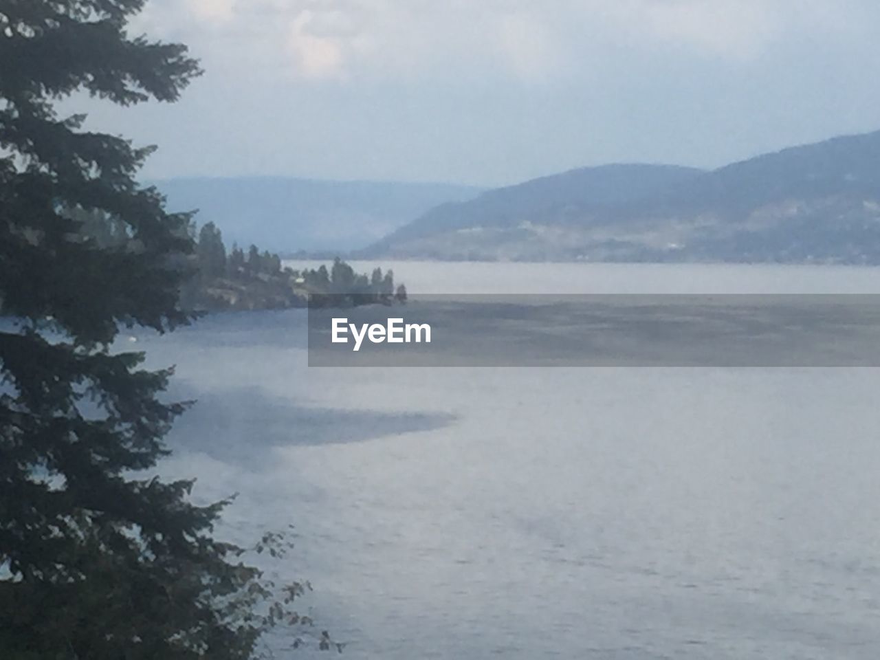 SCENIC VIEW OF SEA WITH MOUNTAINS IN BACKGROUND