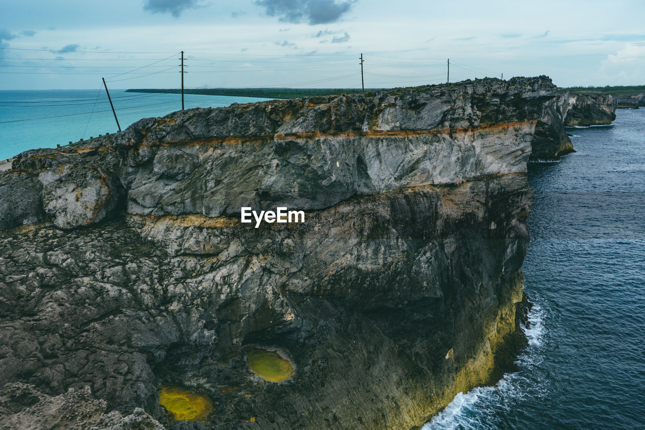 Rock formations by sea against sky