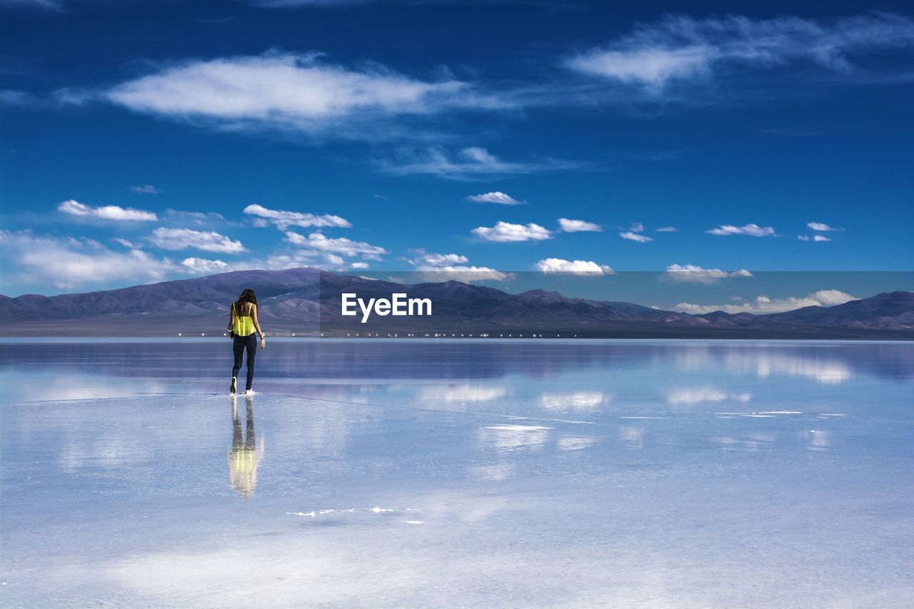 Rear view of woman standing on salt flat in salta, argentina