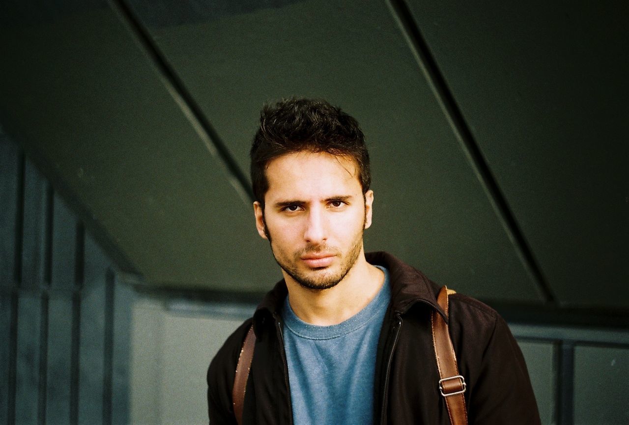 Portrait of young man against ceiling