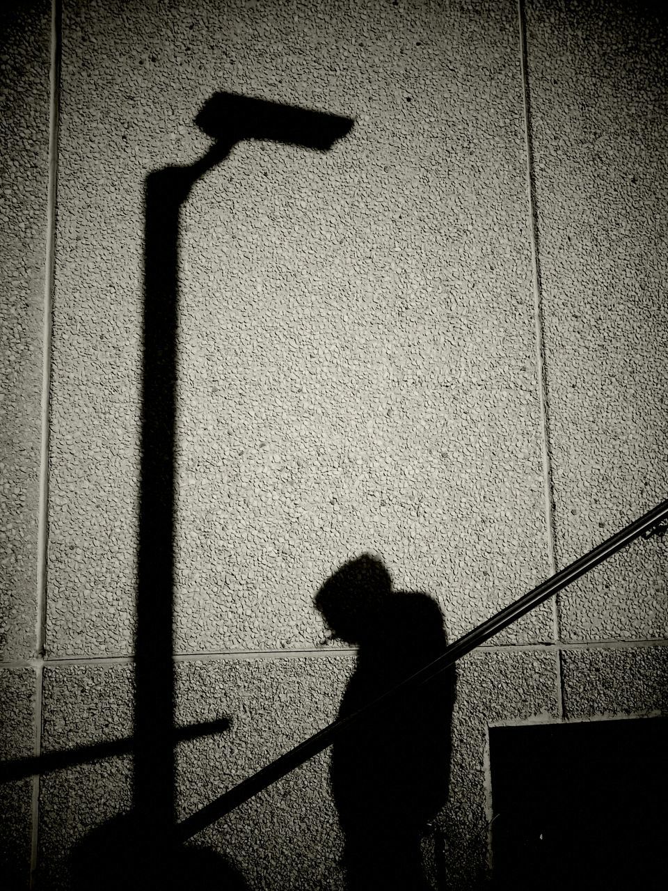 SHADOW OF PERSON ON WALL