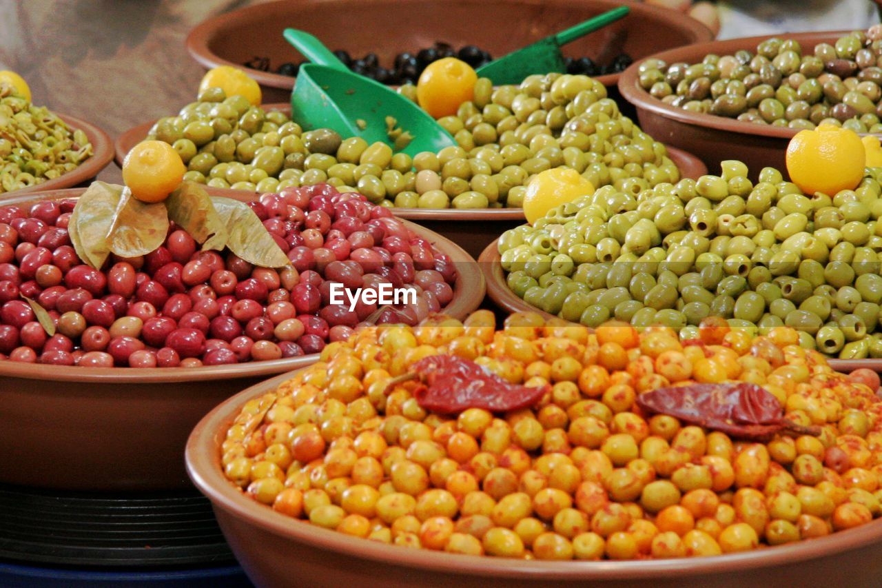 High angle view of colorful olives in container for sale