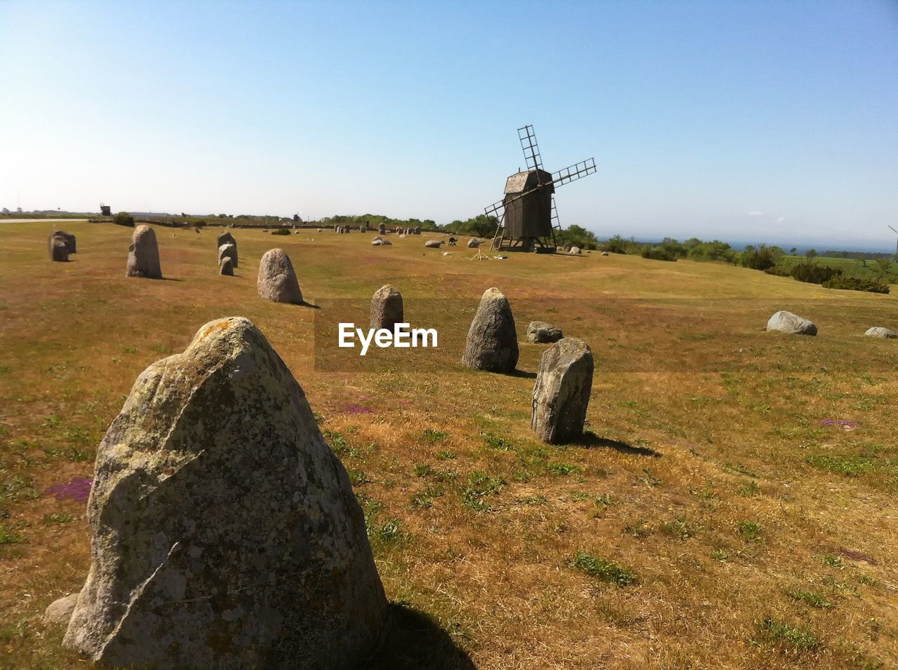 HAY BALES ON LANDSCAPE AGAINST CLEAR SKY