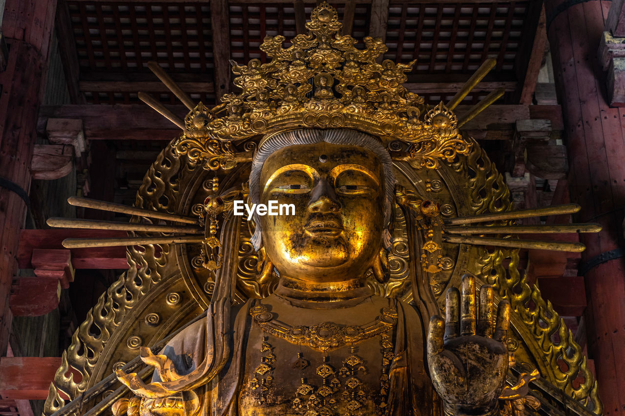 Golden buddha statue at the main hall of the todaiji temple, nara, japan