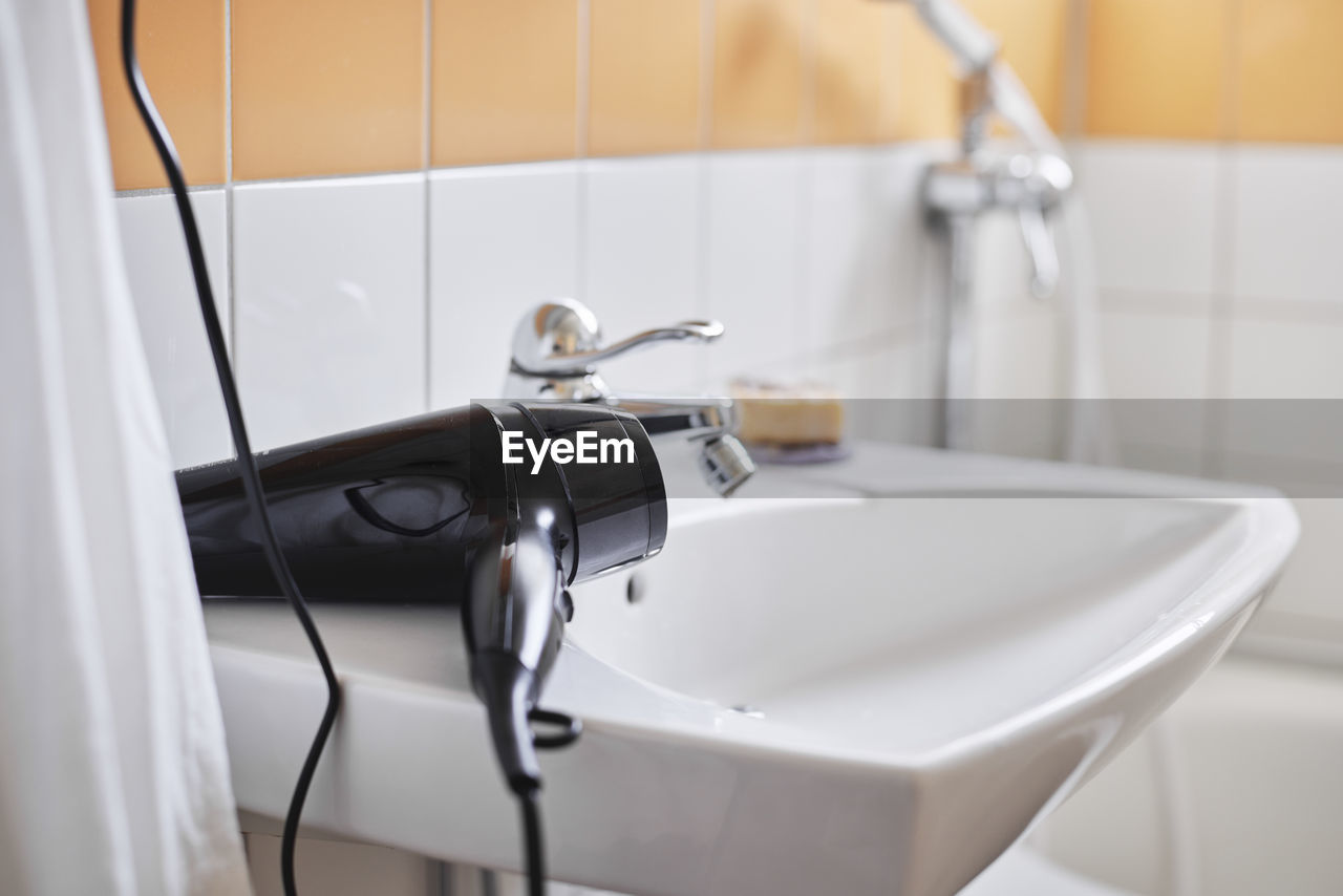 Hair dryer on bathroom sink