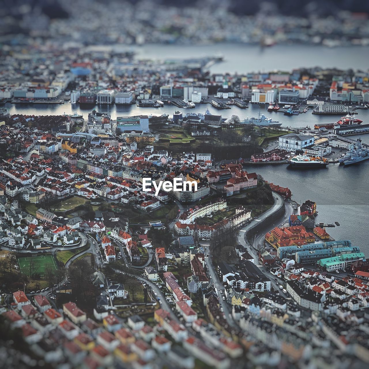 High angle view of city by river against buildings