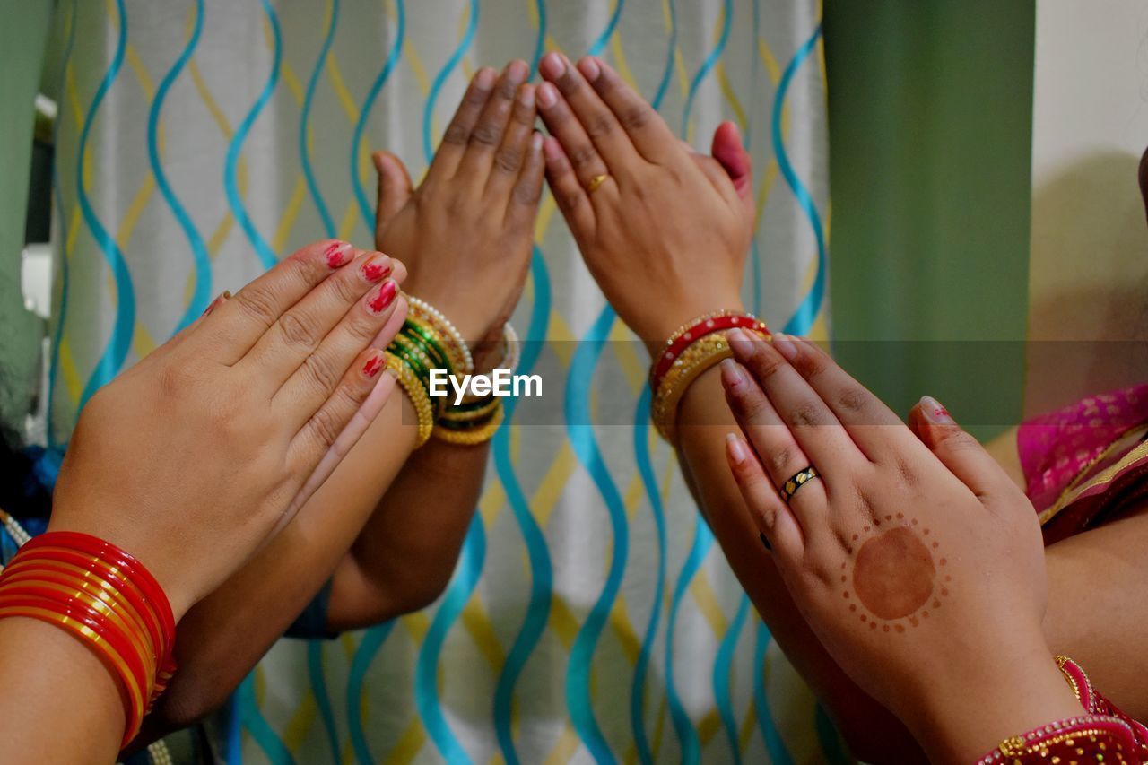Four women's beautiful hand in namste gesture
