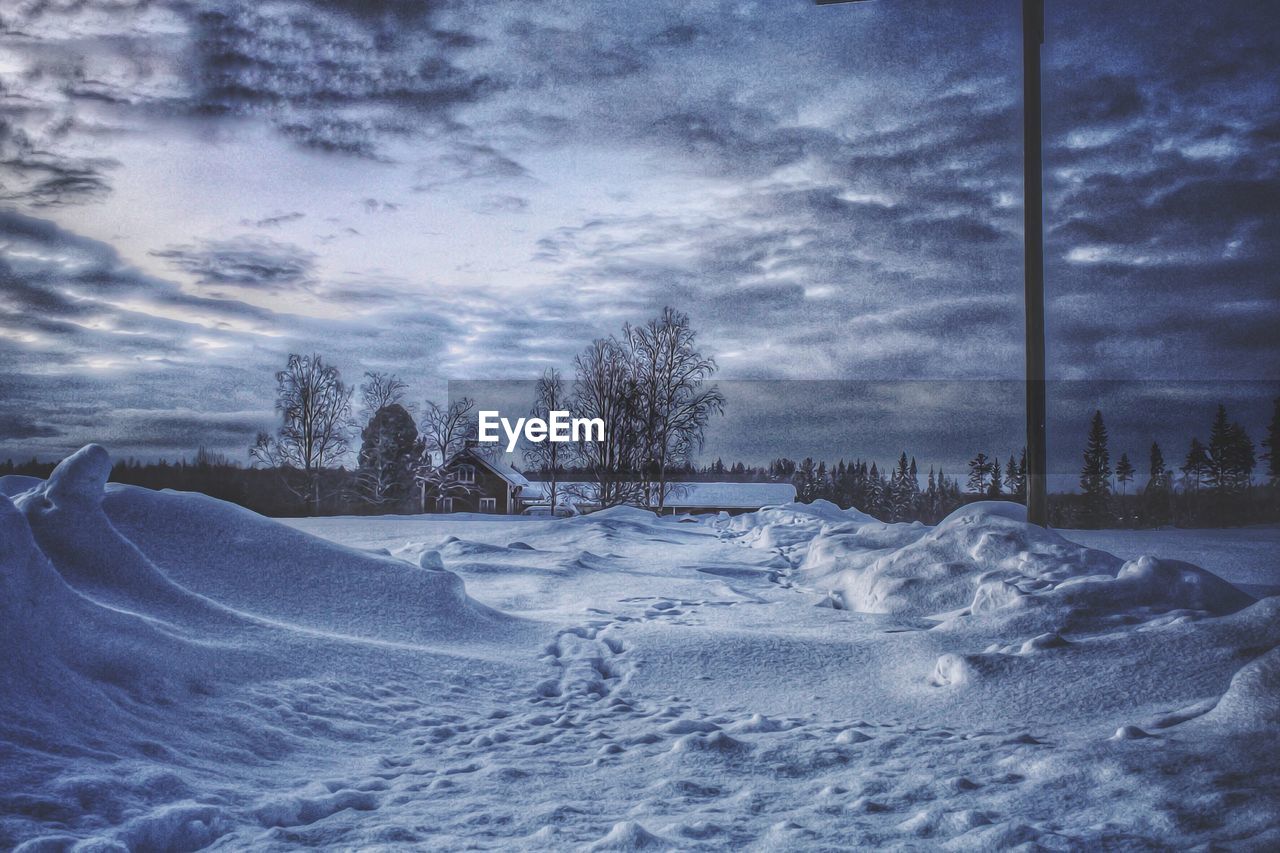 SNOW ON LANDSCAPE AGAINST SKY