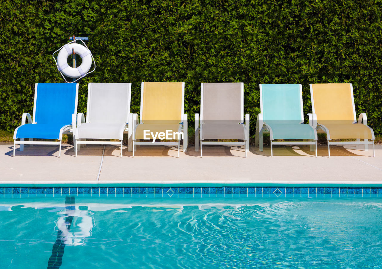 LOUNGE CHAIRS BY SWIMMING POOL