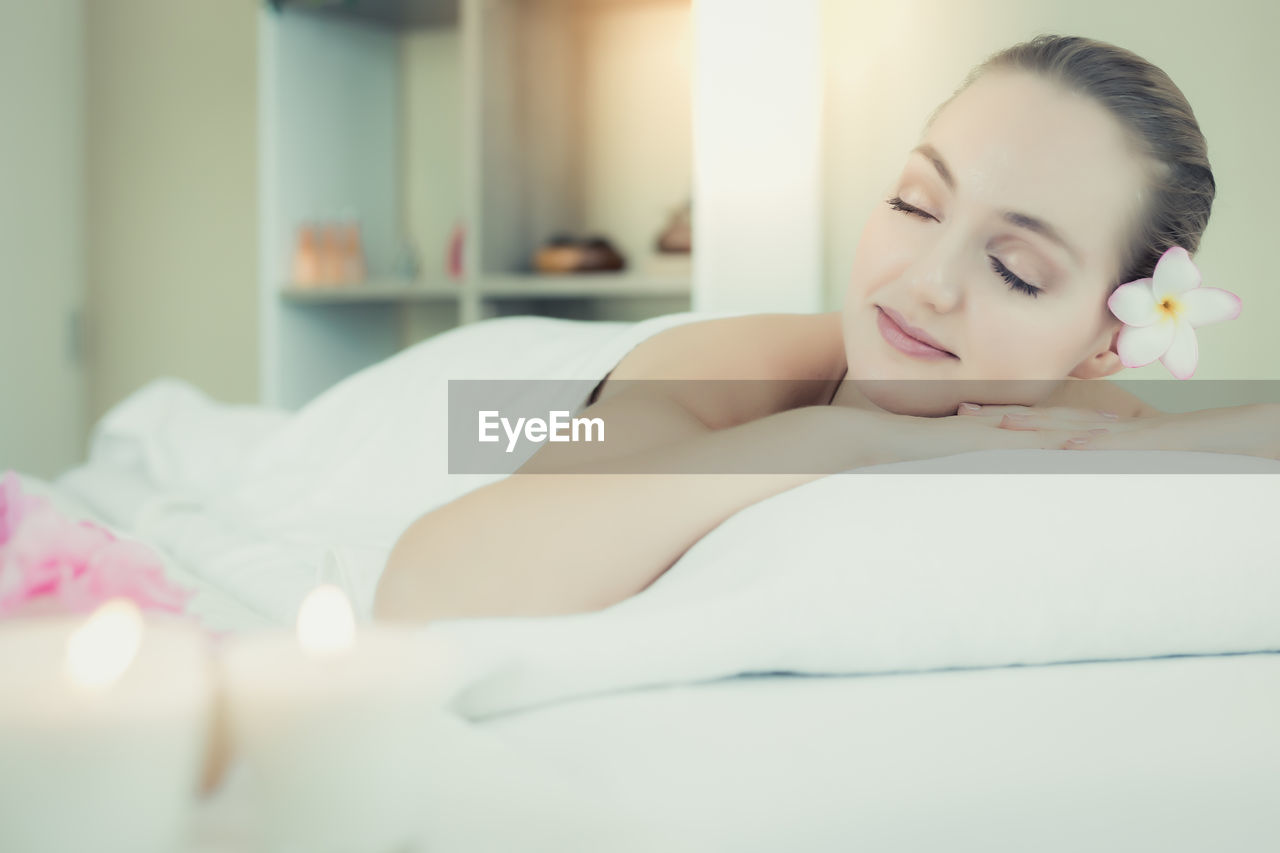 Young woman lying down at beauty spa