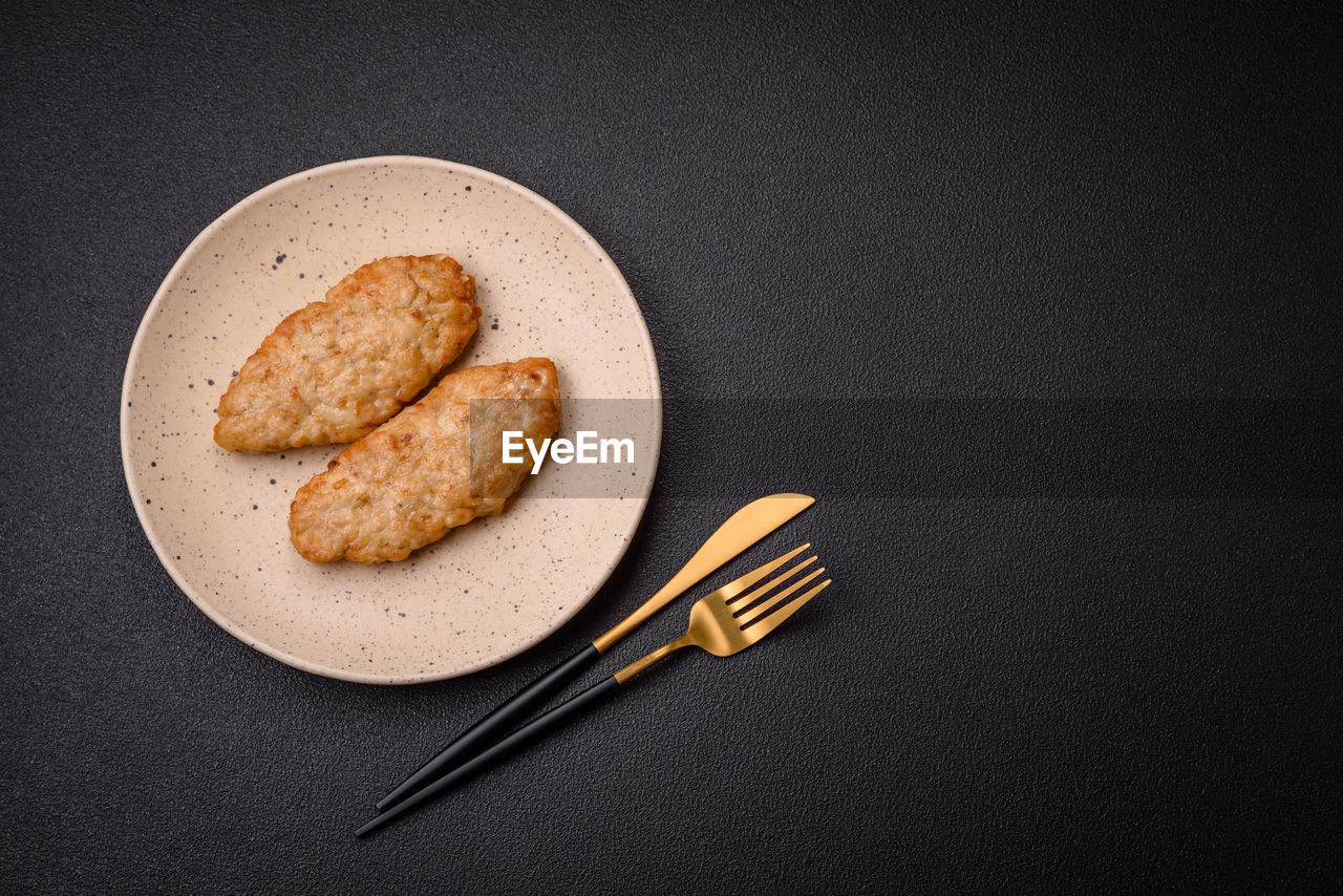 food and drink, food, freshness, studio shot, indoors, plate, black background, no people, kitchen utensil, fork, eating utensil, bread, copy space, still life, baked, directly above, wellbeing, table, healthy eating, high angle view, meal, dessert, simplicity, breakfast, snack, household equipment