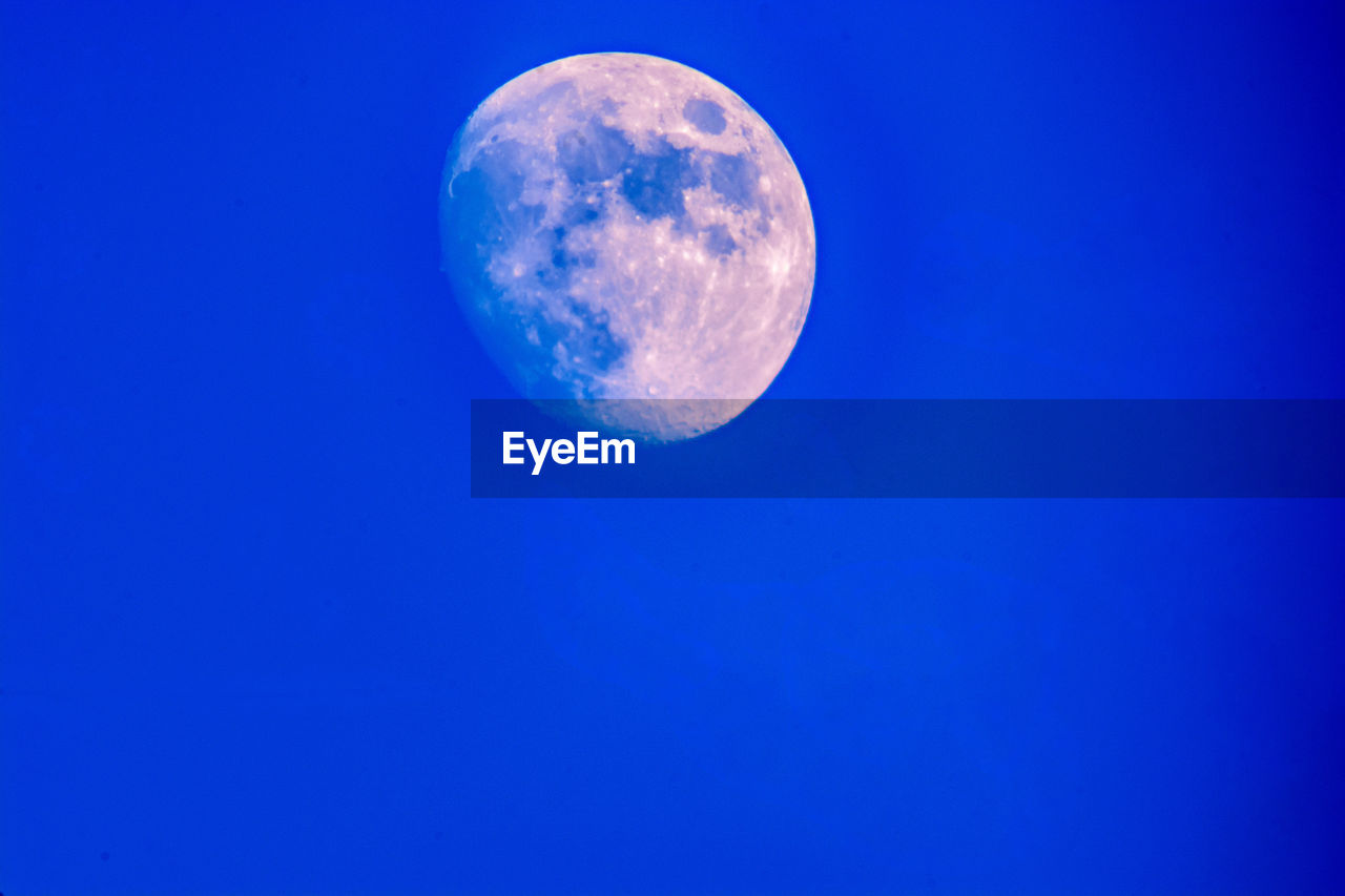 moon, space, blue, sky, astronomy, night, full moon, nature, beauty in nature, no people, moon surface, tranquility, copy space, scenics - nature, planetary moon, low angle view, tranquil scene, astronomical object, outdoors, clear sky, astrology, space and astronomy, space exploration, idyllic, science, exploration, discovery