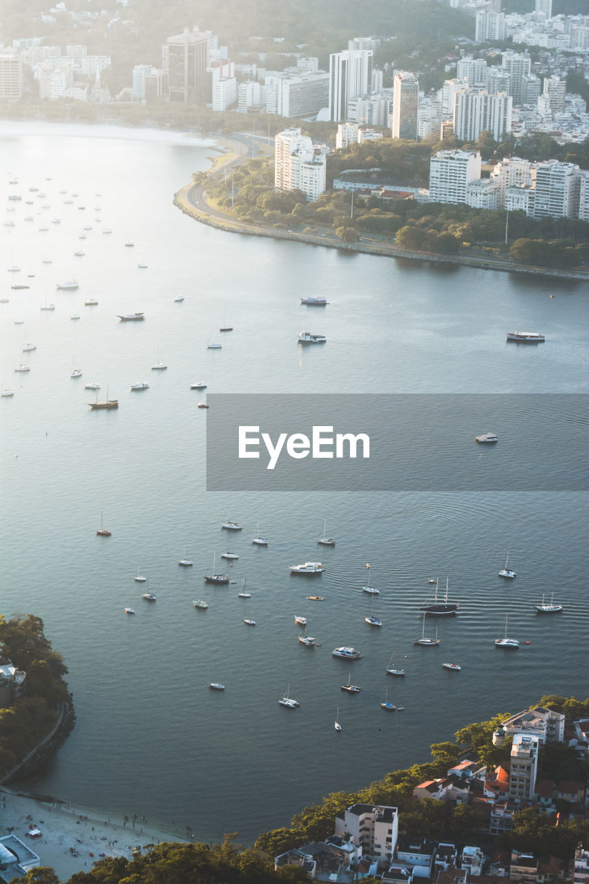 High angle view of sea and buildings in city