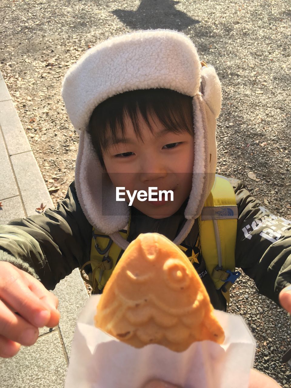 CLOSE-UP PORTRAIT OF BOY HOLDING FOOD