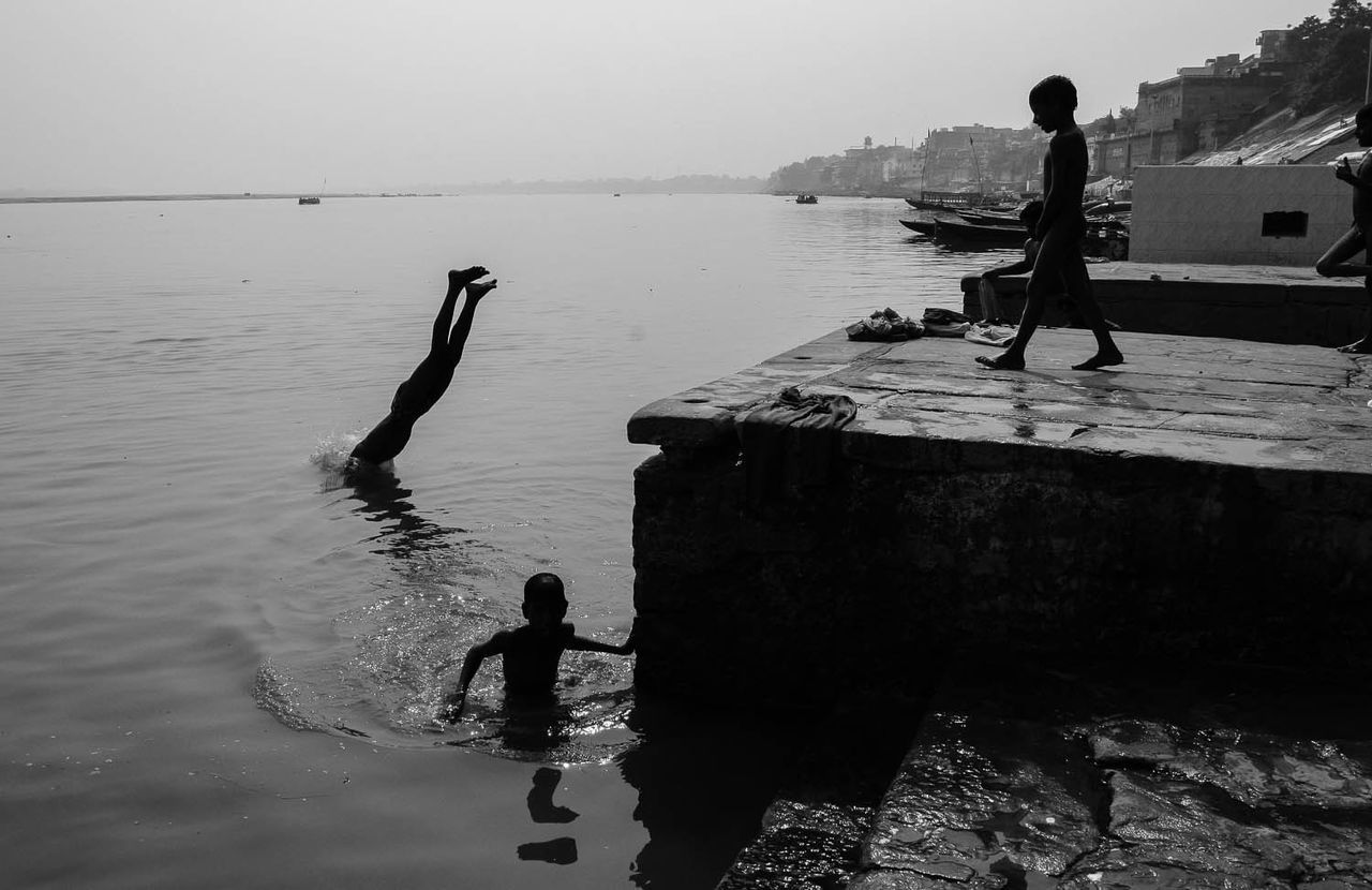 BOY STANDING ON SEA SHORE