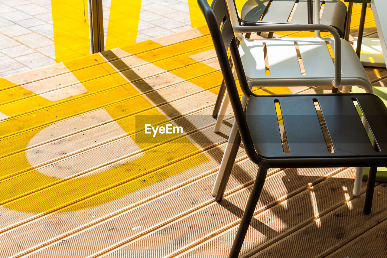 High angle view of chairs on wooden floor