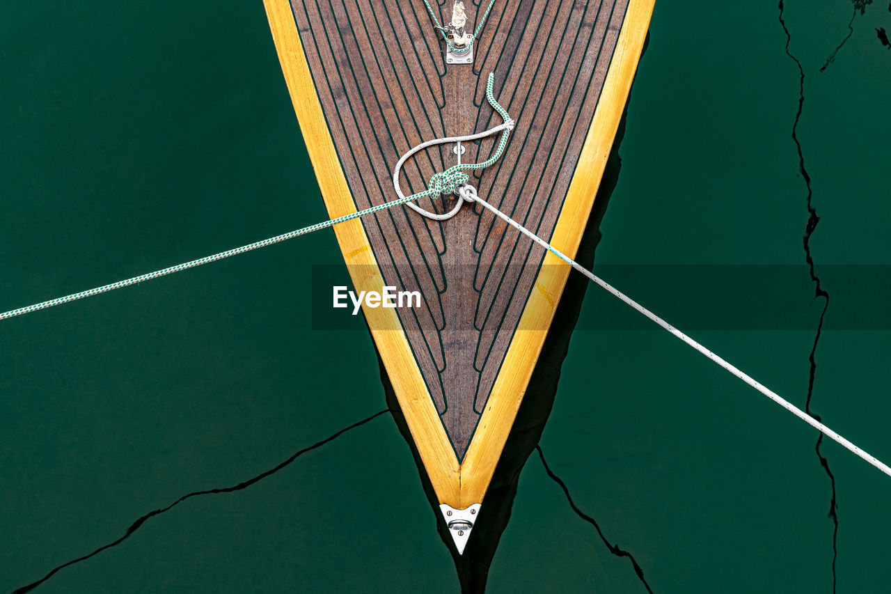 High angle view of ropes tied to boat on lake