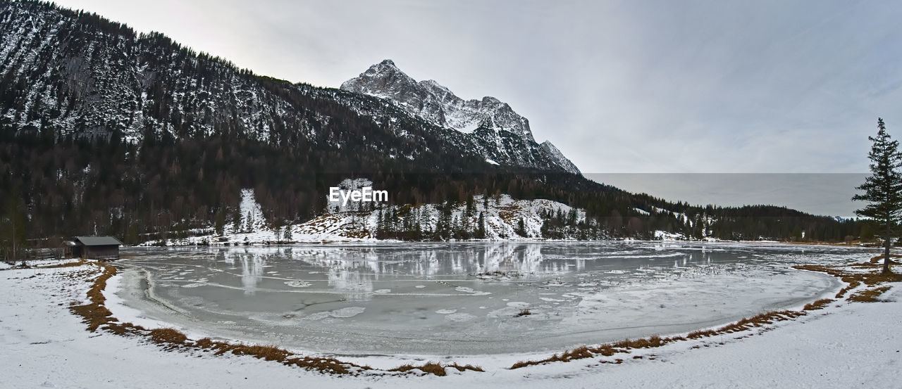 Scenic view of frozen lake against sky during winter