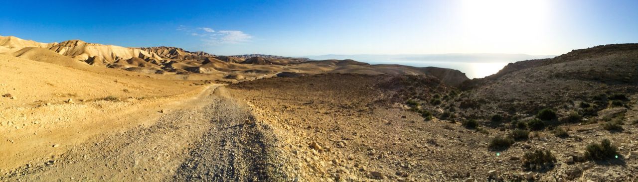 Panoramic shot of dirt road along landscape