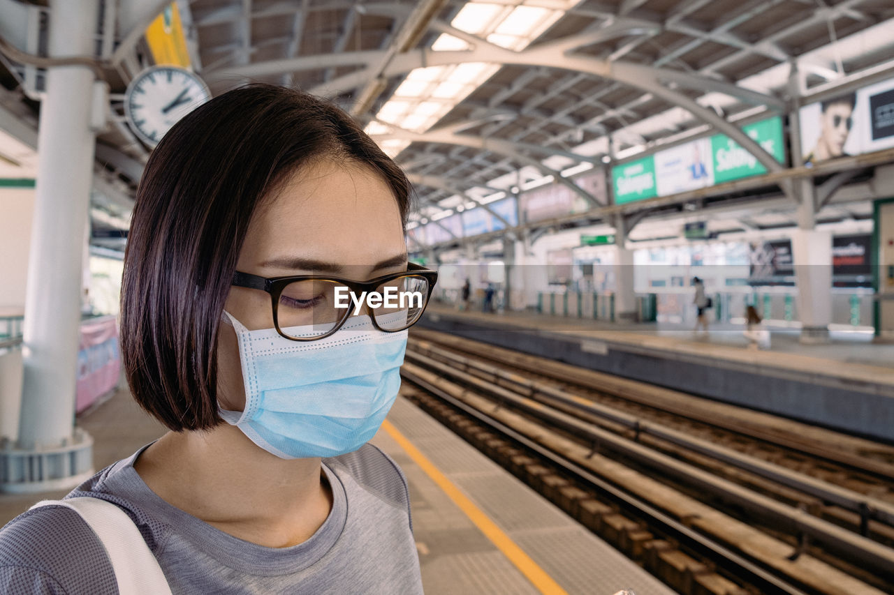 PORTRAIT OF WOMAN ON RAILROAD STATION