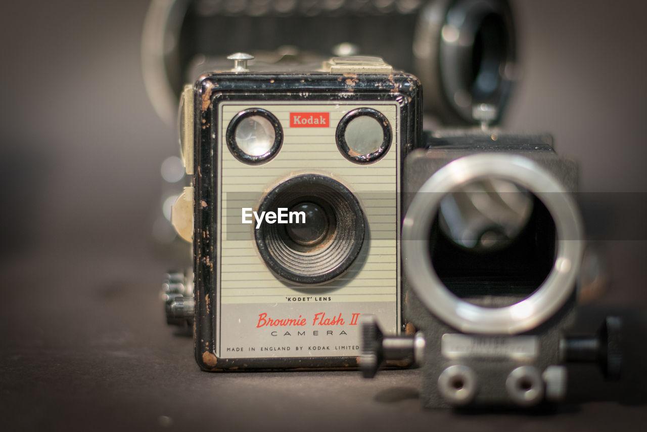 CLOSE-UP OF VINTAGE CAMERA ON TABLE WITH COMPUTER