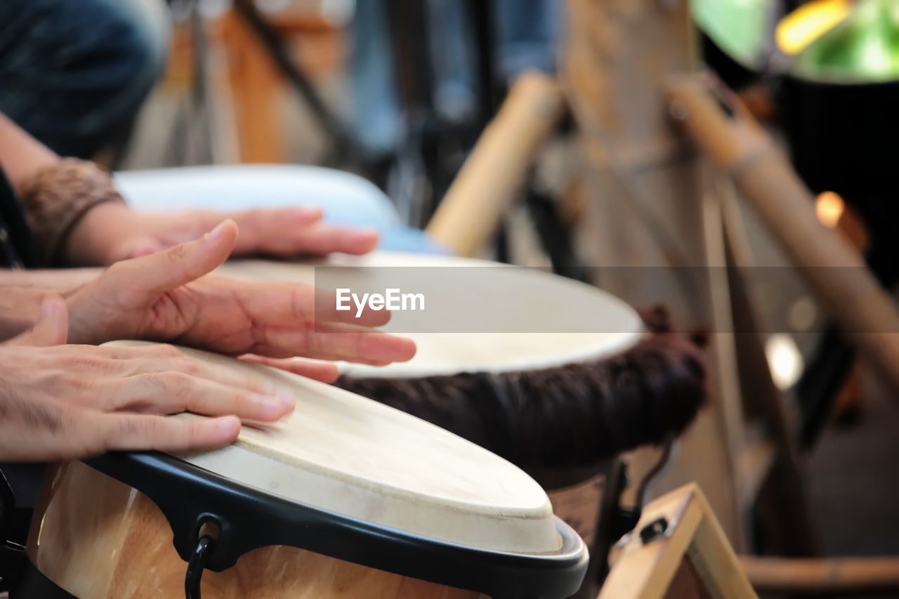 Cropped hands playing bongos