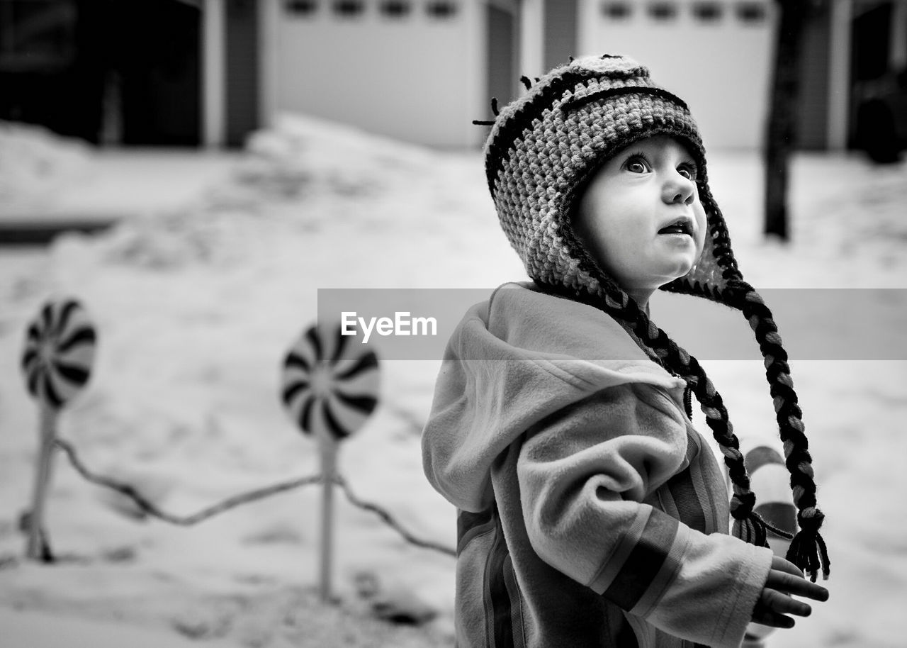 Close-up of young boy in front yard in winter