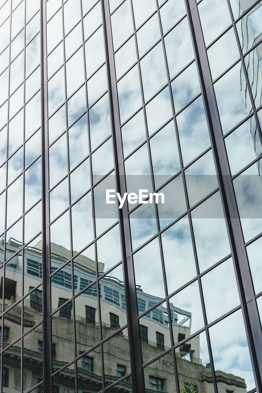 LOW ANGLE VIEW OF MODERN BUILDINGS AGAINST SKY