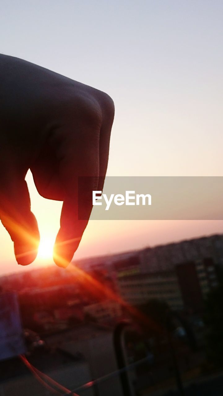 CLOSE-UP OF SILHOUETTE MAN AGAINST SUNSET SKY