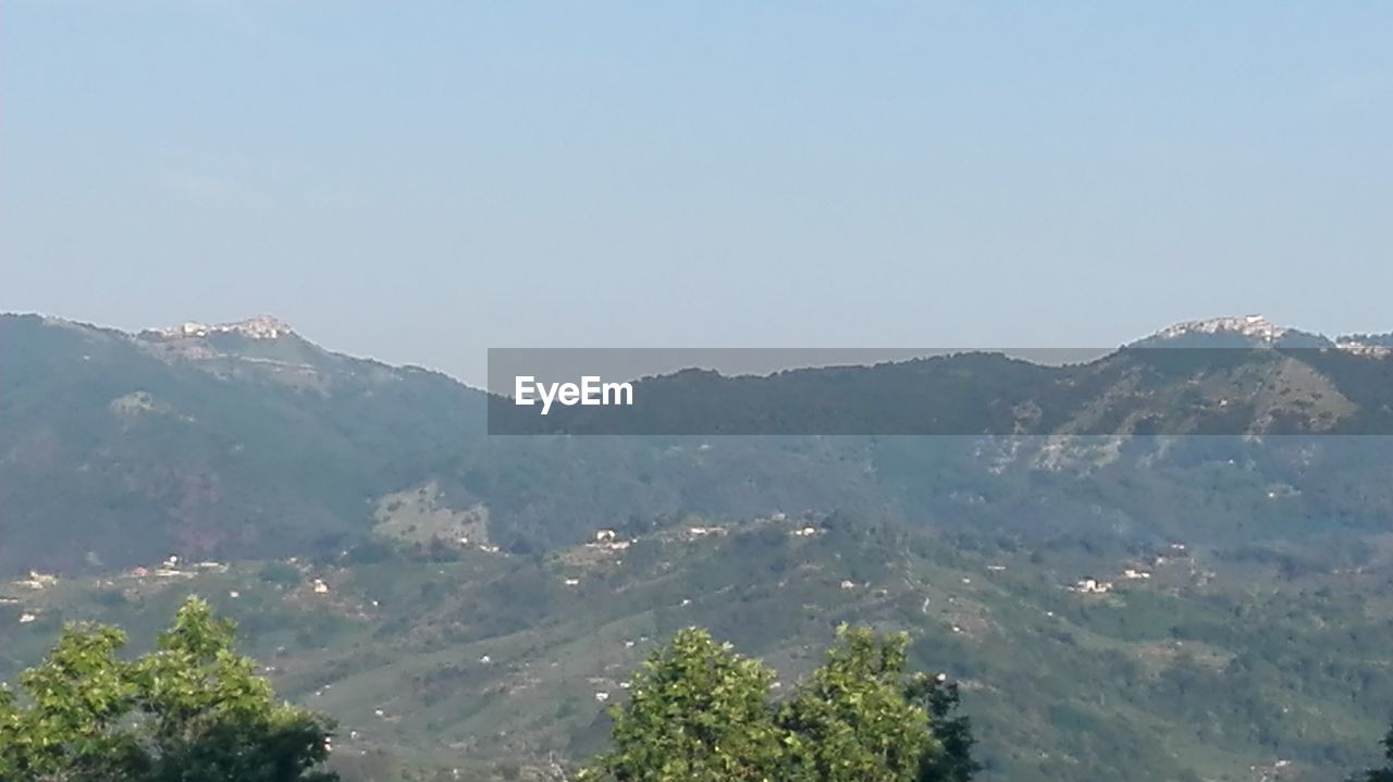 SCENIC VIEW OF TREE MOUNTAINS AGAINST SKY