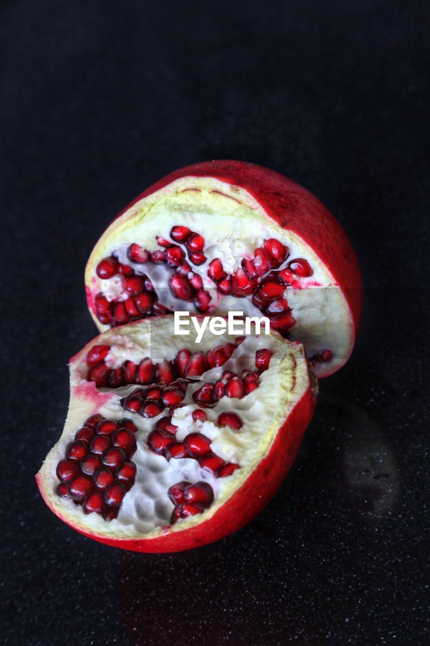 Close-up of pomegranate against black background