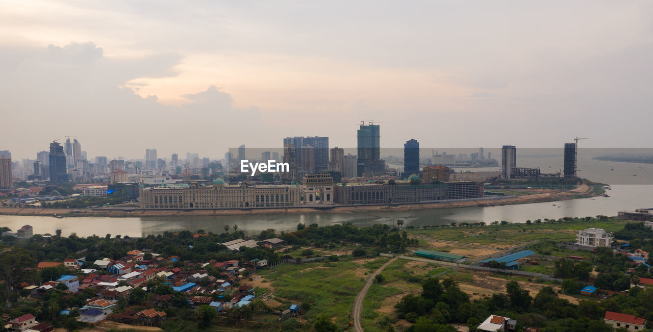 HIGH ANGLE VIEW OF BUILDINGS AGAINST SKY DURING SUNSET