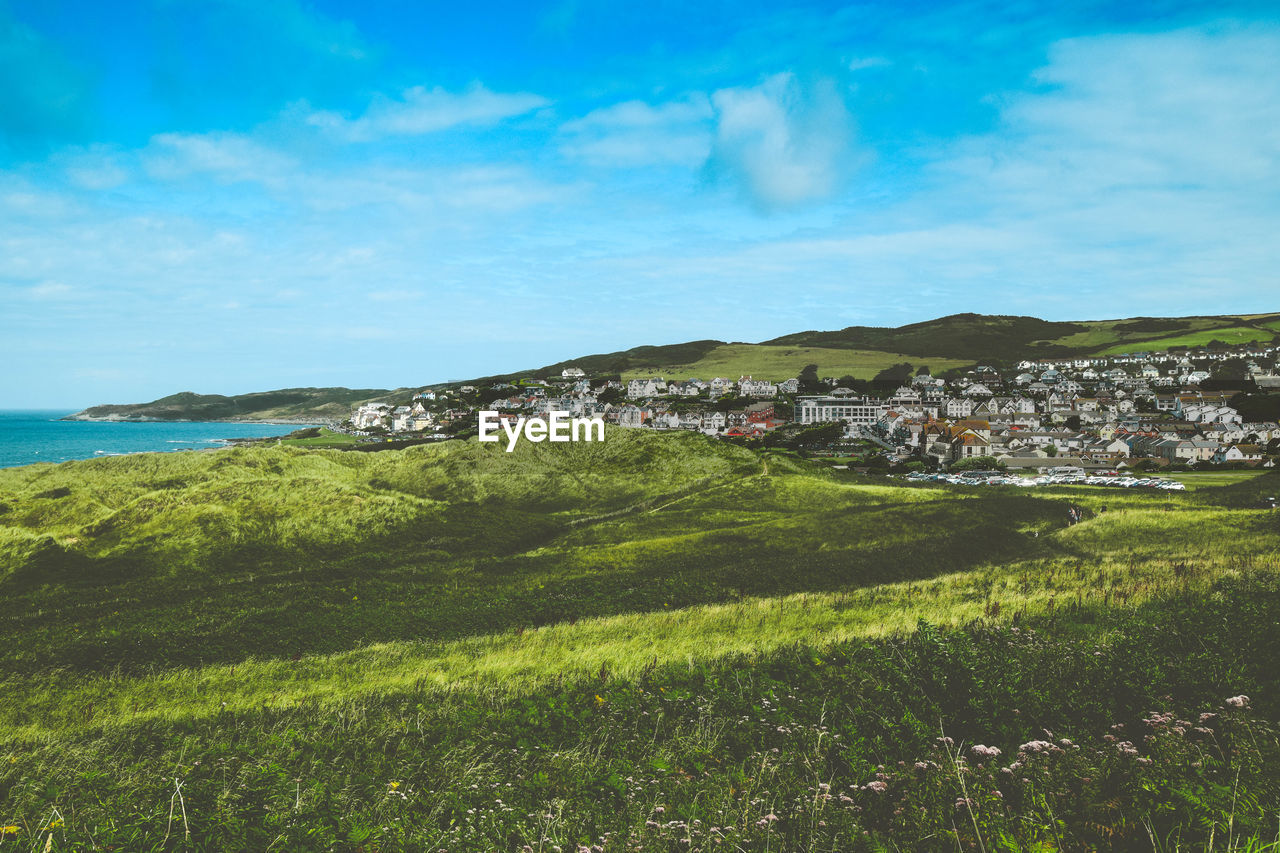 Scenic view of landscape and buildings against sky