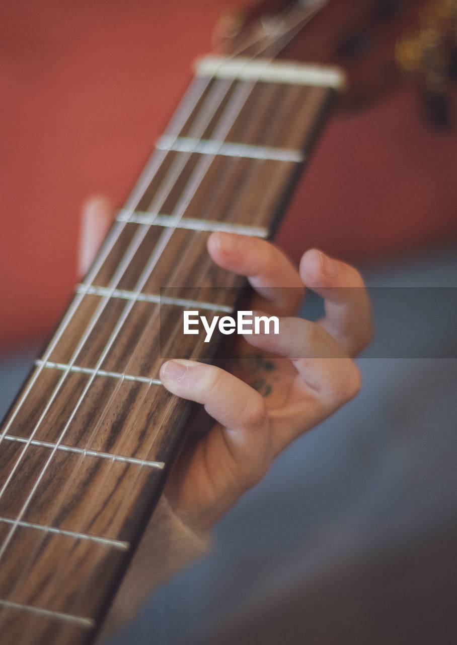 Little girl plays the guitar.