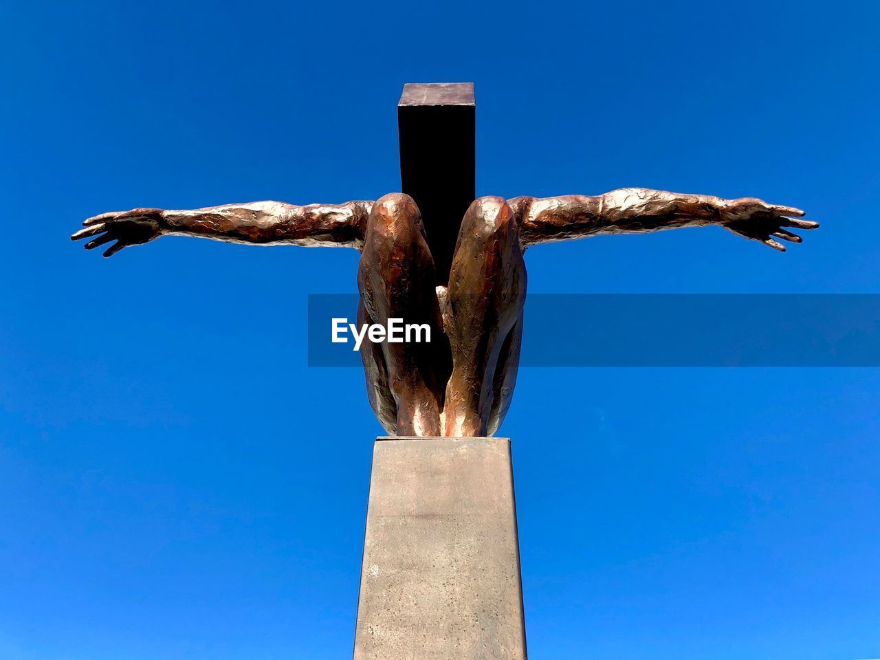 LOW ANGLE VIEW OF CROSS AGAINST BLUE SKY