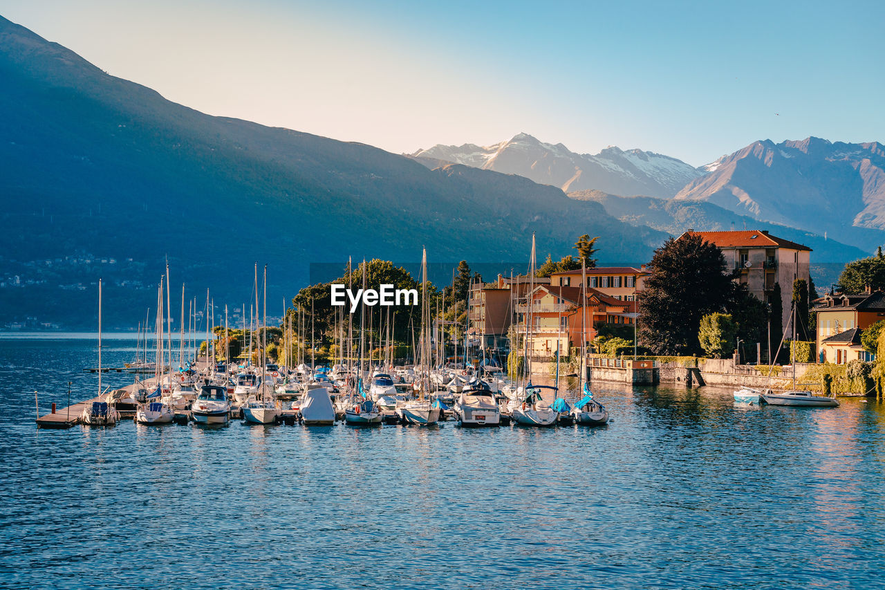 Pier on lake como with boats moored at sunset